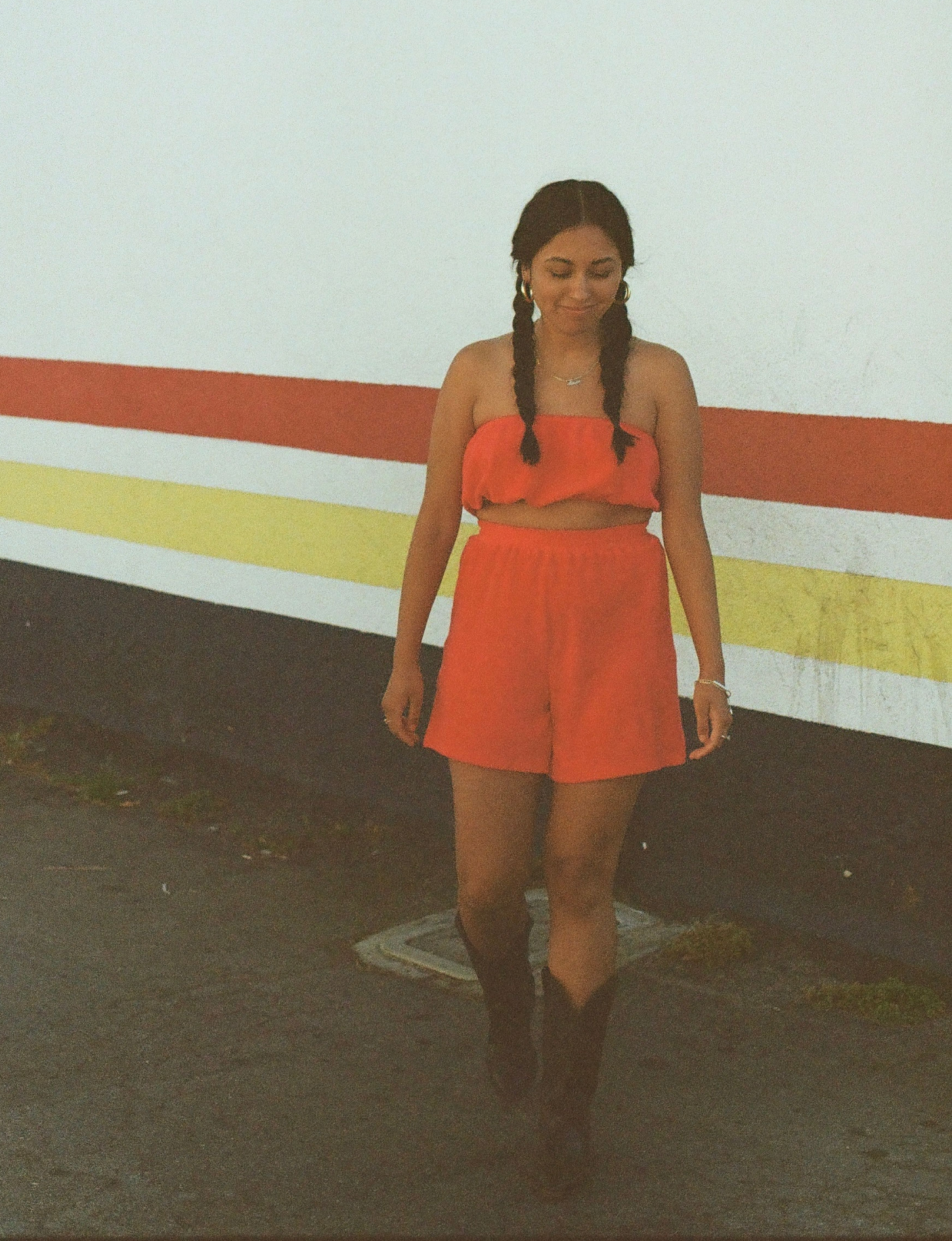 styled on film wearing matching organic red terry cloth tube top and shorts with cowboy boots