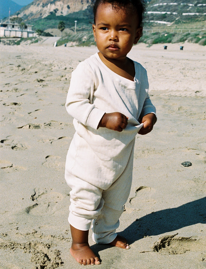lifestyle beige sand pointelle onesie on the beach shot on film